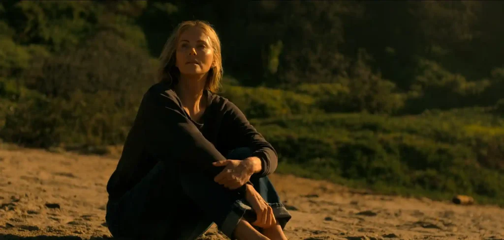Charlize Theron sitting in Wandarra National Park after climbing the mountain