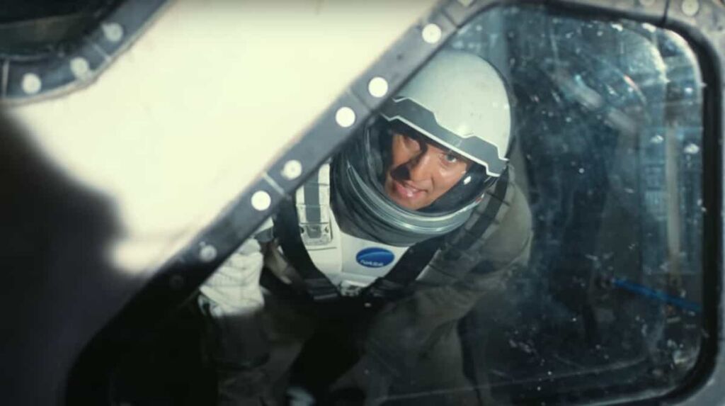 Interstellar 2 movie scene featuring Matthew McConaughey as Cooper coming out from spacecraft while wearing wearing spacesuit