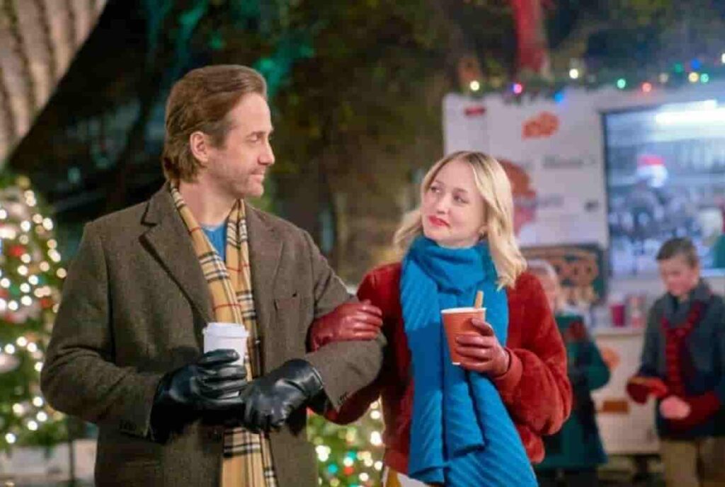 Niall Matter and Emily Tennant smiling during the filming of Holiday Hotline Hallmark movie in Winnipeg