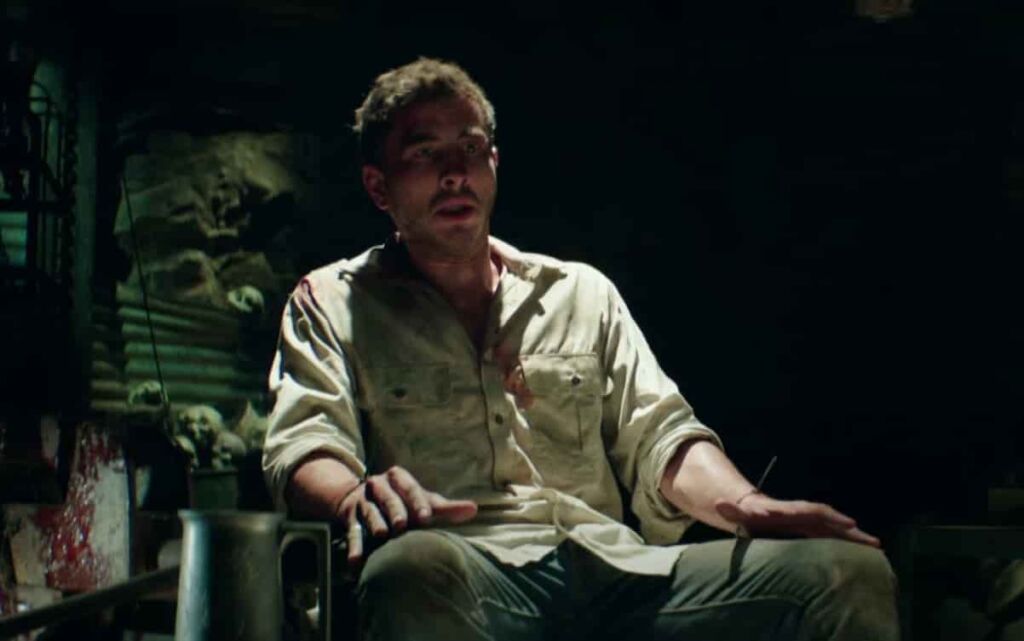 Wolf Creek 2 showing Ryan Corr as Paul tied on a chair by Mick Taylor