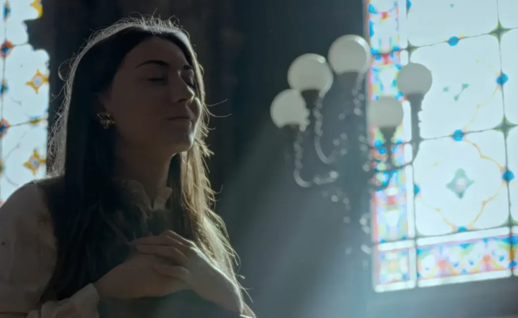 Sacred Heart: His Reign Has No End movie scene featuring Saint Margaret Mary Alacoque remembering the Jesus dream while holding hands on her heart
