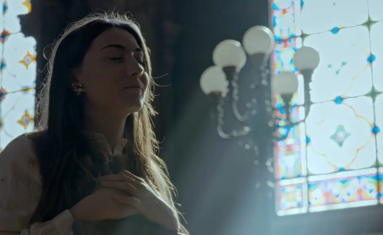 Sacred Heart His Reign Has No End: Where to Watch, Cast, and Reviews (2026) Sacred Heart: His Reign Has No End movie scene featuring Saint Margaret Mary Alacoque remembering the Jesus dream while holding hands on her heart