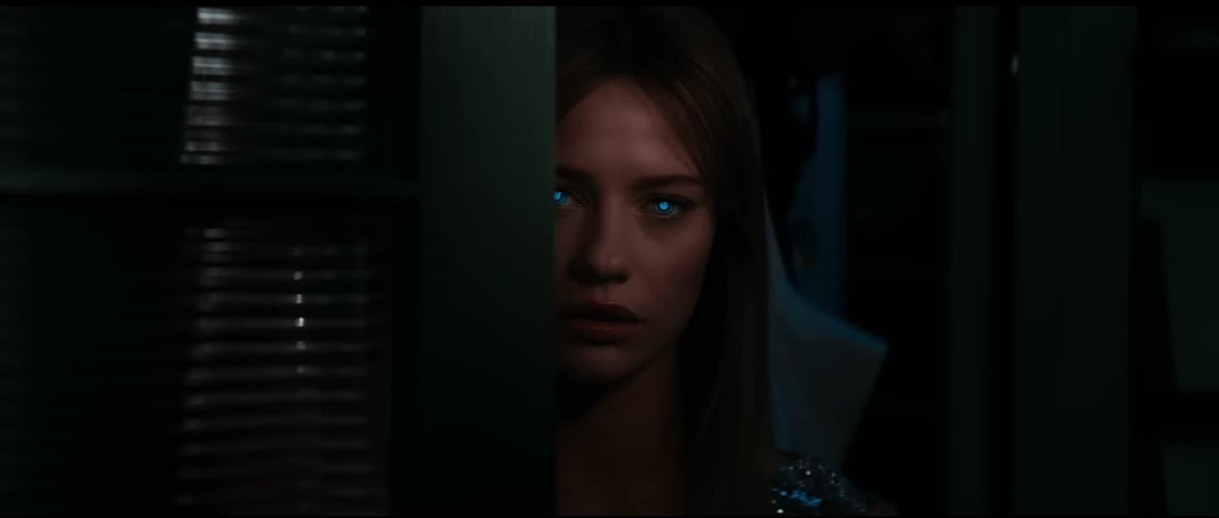 Soulm8te (2026): Where to Watch, Stream, Rent, and Buy Online Lily Sullivan as SARA the AI android in Soulm8te 2026, peering around a dark doorway with glowing blue eyes