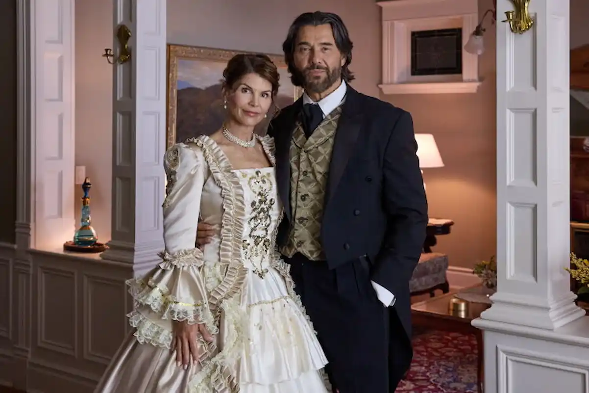 Where was Garage Sale Mysteries: Murder Takes the Stage filmed? Locations, Cast, and Everything Lori Loughlin as Jennifer and Steve Bacic as Jason in Victorian-era costumes inside a historic home in Garage Sale Mysteries: Murder Takes the Stage.