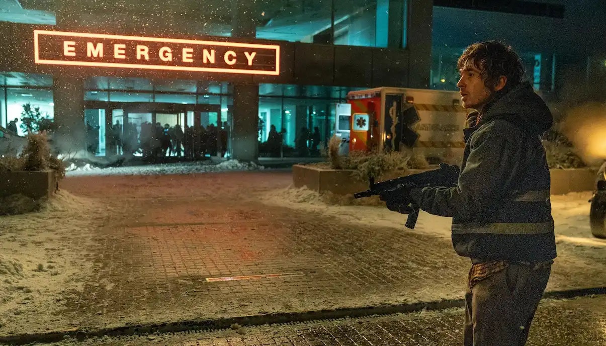 Where was Resident Evil (2026) filmed? Every Location Explained Brian holds a rifle outside a snow-covered emergency hospital during a night scene from Resident Evil (2026), filmed in Prague.