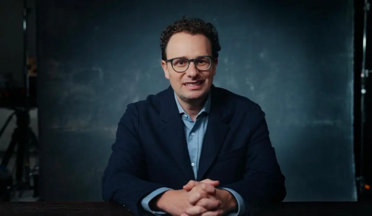 Where to watch The AI Doc: Or How I Became an Apocaloptimist? Daniel Amodei speaking about artificial intelligence in a dimly lit studio scene from The AI Doc: Or How I Became an Apocaloptimist documentary